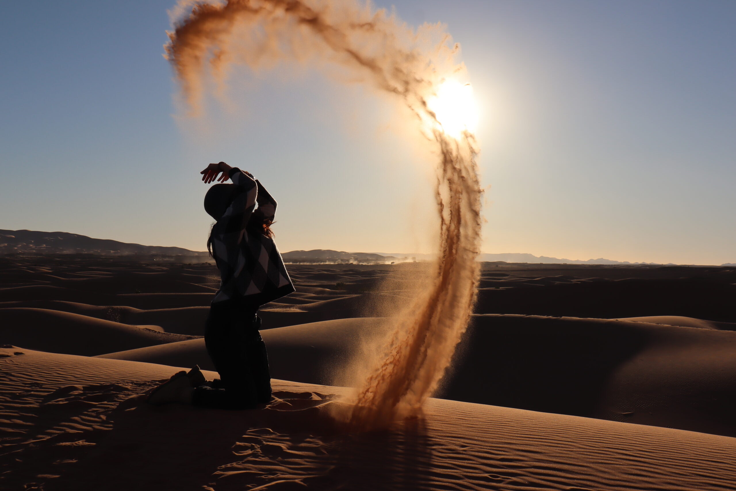 playing with sand on sahara morocco